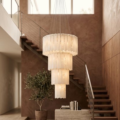 Alabaster staircase cascade chandelier in a warm foyer